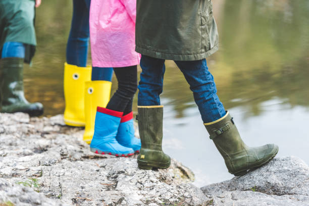 istock family in rubber boots standing on rock 875326358