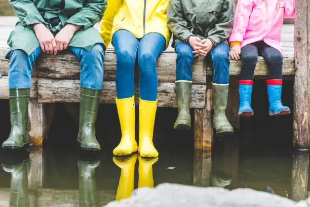 Photo of family sitting on wooden bridge