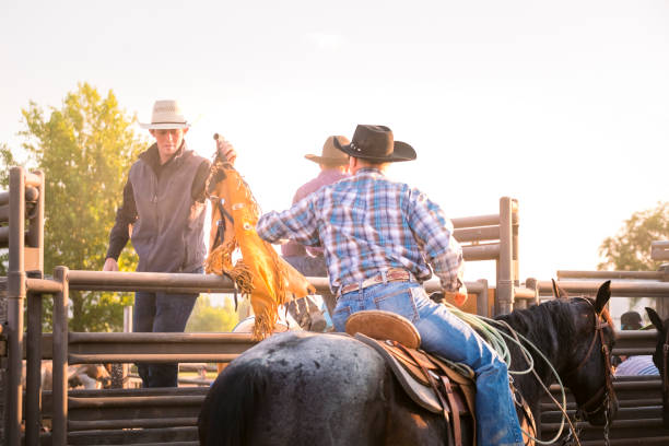 istock Cowboys Chat Together On Horseback At Dawn 875327236