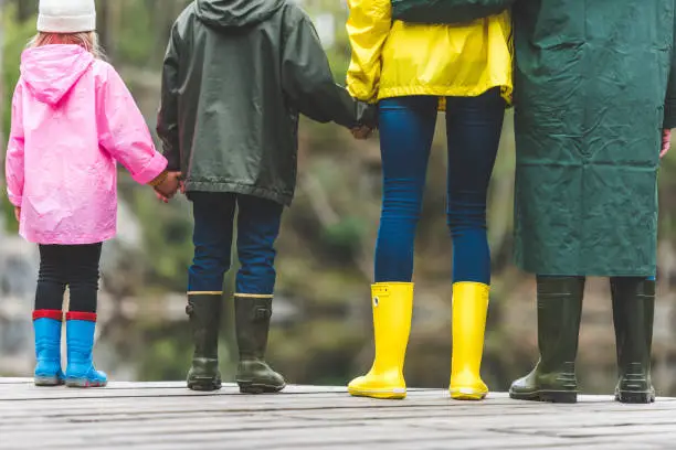 Photo of family standing on wooden bridge