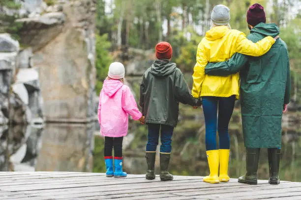 Photo of family standing on wooden bridge