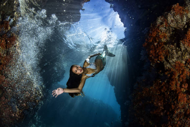 istock Mermaid swimming underwater in the deep blue sea 875328166
