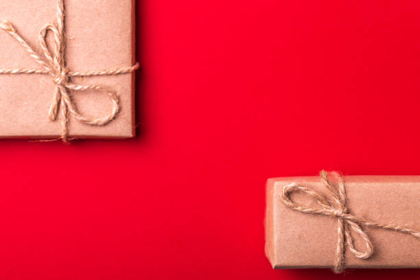 istock Gift box on red background. Flat lay. Color surge. 875328506