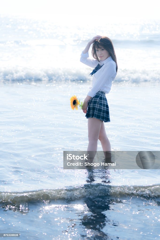 Schoolgirl on a beach Female senior high school student on a beach Adult Stock Photo