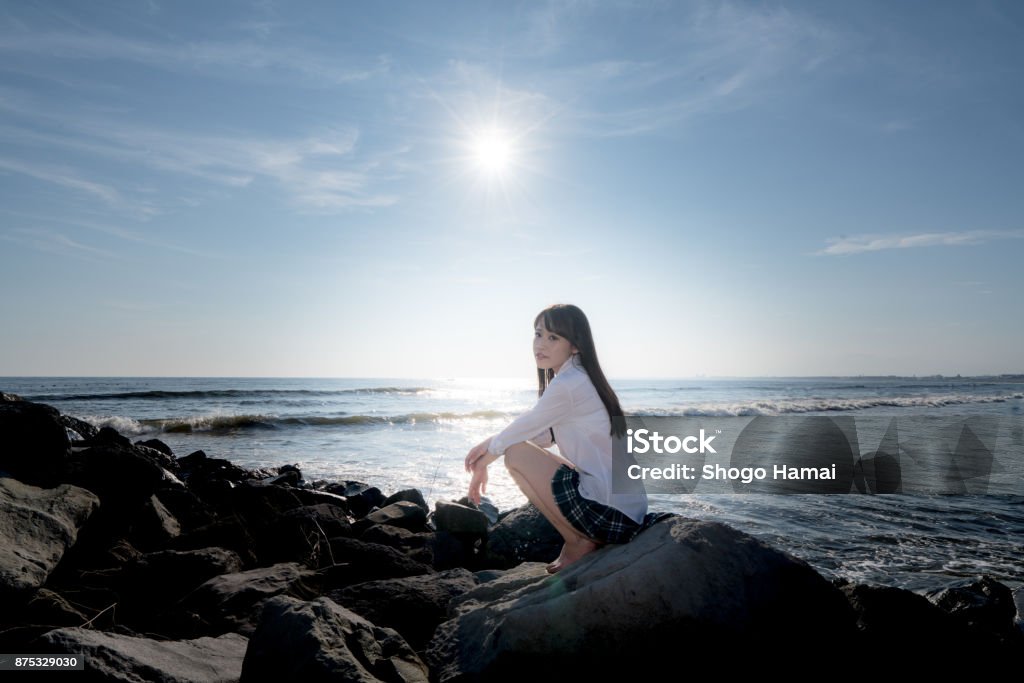 Schoolgirl on a beach Female senior high school student on a beach Adult Stock Photo