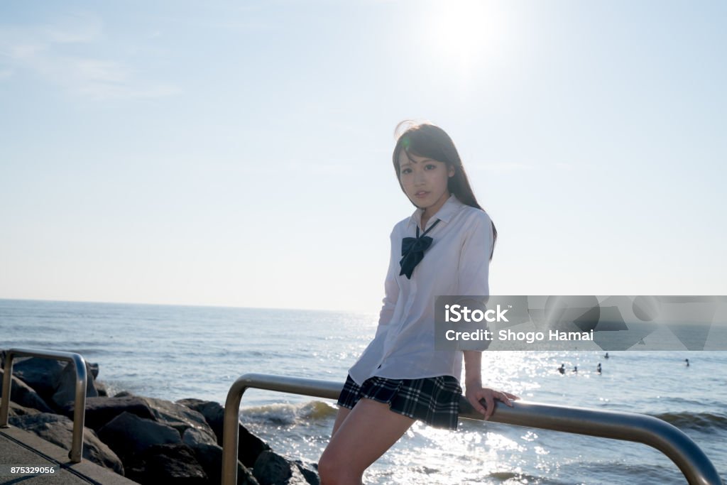 Schoolgirl on a beach Female senior high school student on a beach Adult Stock Photo