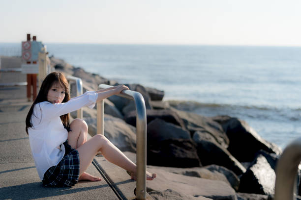 istock Schoolgirl on a beach 875329124