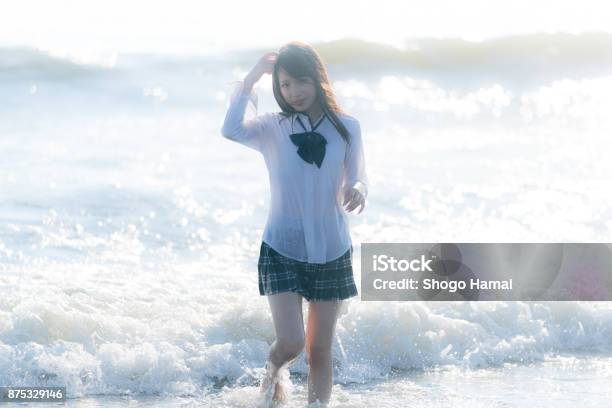 Schoolgirl On A Beach Stock Photo - Download Image Now - Beautiful People, Cute, Japanese School Uniform