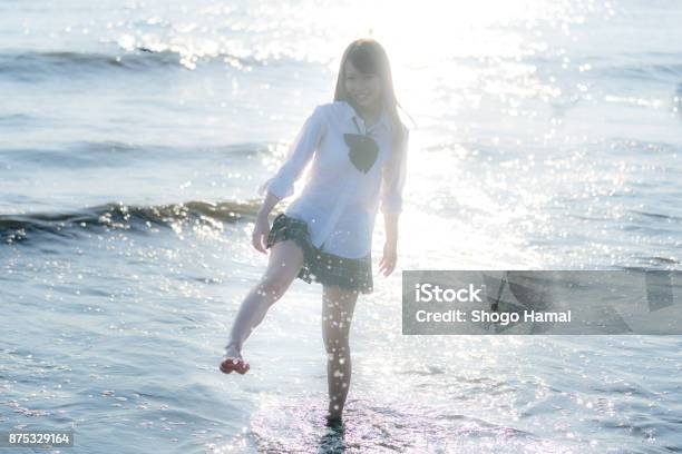 Schoolgirl On A Beach Stock Photo - Download Image Now - Adult, Adults Only, Beach
