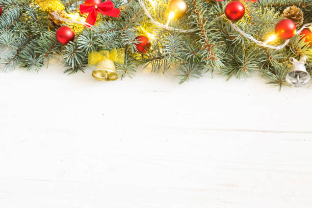 istock Christmas gift box and fir tree branch on wooden table. Top view with copy space 875332312
