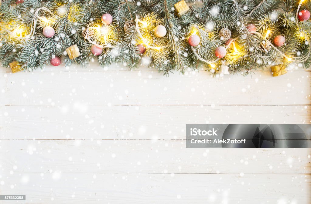 Christmas background with fir tree and decoration on white wooden board Christmas background with fir tree and decoration on white wooden board. 2018 Stock Photo
