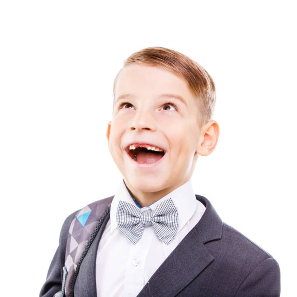 istock Excited school boy with toothless smile looking up 875348952