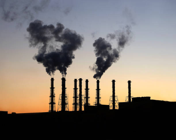 istock Power station building with many high smoke pipes after sunset 875362780