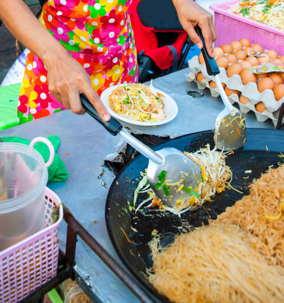 istock Chef making a serving of fresh stir fry and wok 875362866