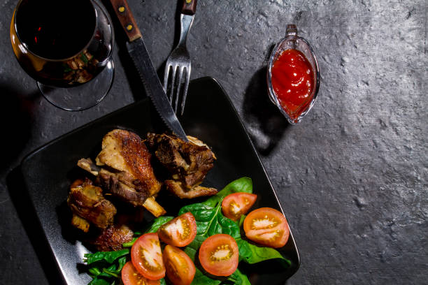 istock Beef ribs and spinach and tomato leaves salad 875363436