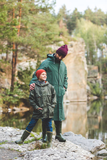 istock father and son in autumn forest 875364182