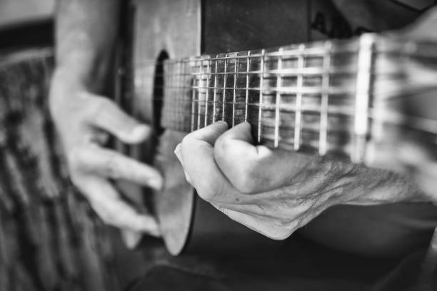 istock Man hands playing acoustic guitar, close up 875373334