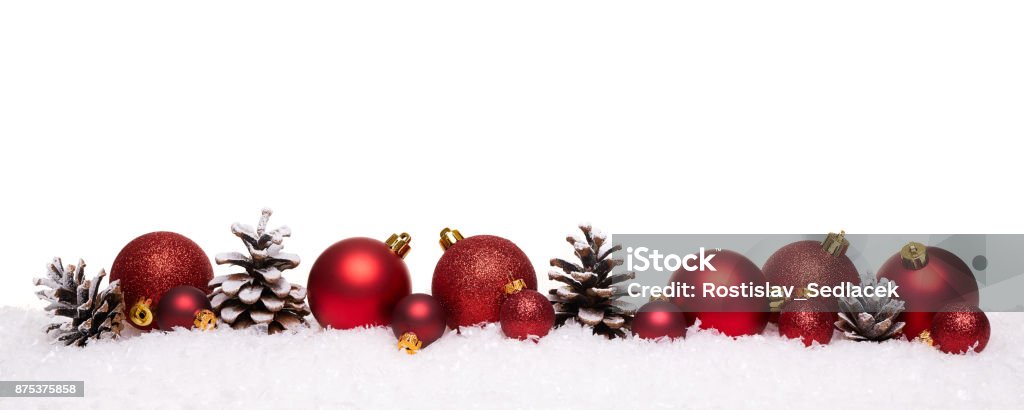 Red christmas balls and pine cones isolated on snow Red christmas balls and pine cones isolated on snow, Christmas banner Christmas Ornament Stock Photo