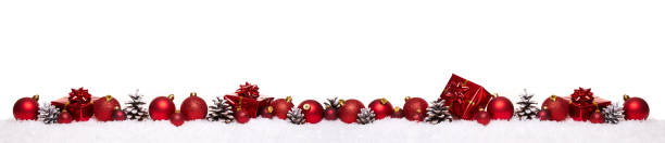 istock Red christmas balls with xmas present gift boxes in a row isolated on snow 875375890