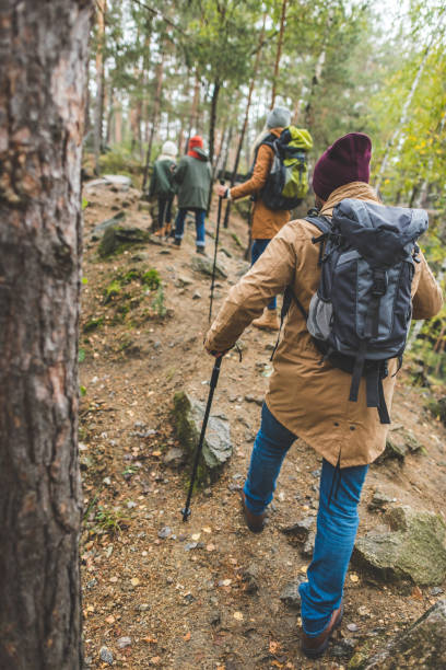istock parents and kids trekking in forest 875375894