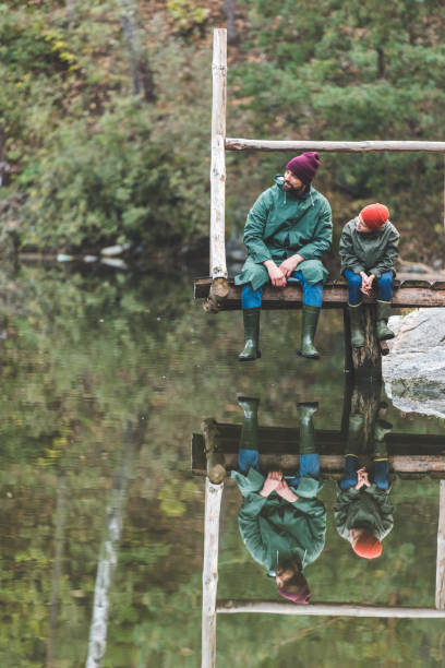 istock father and son near lake 875382956