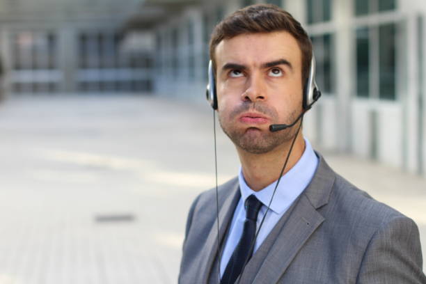 Frustrated customer service worker rolling his eyes Frustrated customer service worker rolling his eyes. rolling eyes stock pictures, royalty-free photos & images