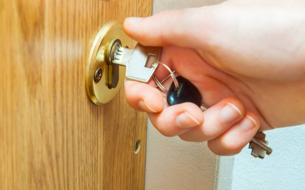 istock Locking up or unlocking door with key in hand 875383256