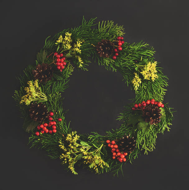 istock Christmas decorative wreath  with ornament  on black background. Made from thuja, flower, pine cones. Floral design. Festive mod. 875383350