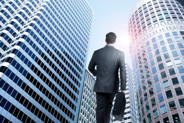istock Businessman Walking Toward Skyscrapers 875384272