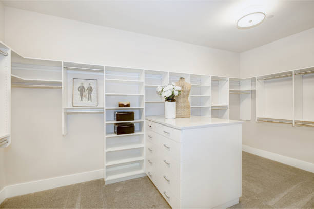 istock Huge walk-in closet with shelves, drawers and clothes rails 875391088