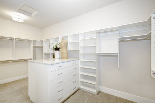 istock Huge walk-in closet with shelves, drawers and clothes rails 875391432