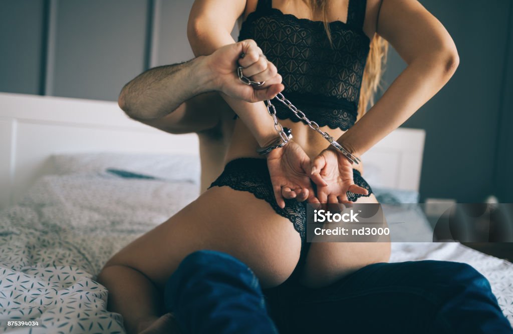 Woman and man playing domination games in bed Woman and man playing domination games in bed together Sensuality Stock Photo