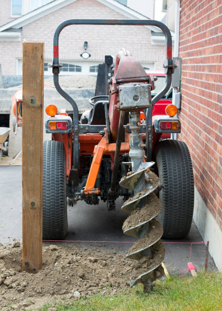 Earth Auger drilling fence post holes