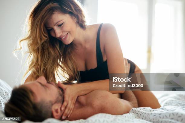 Attractive Couple Sharing Intimate Moments In Bedroom Stock Photo - Download Image Now