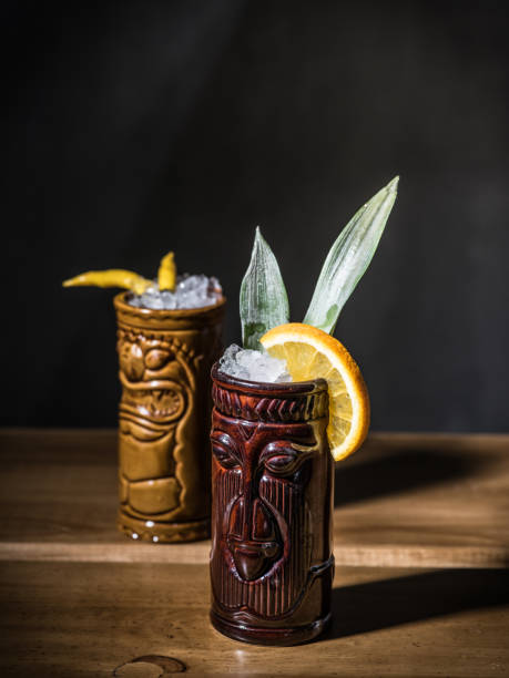 istock Exotic tropical tiki cocktails on a black background 875398512