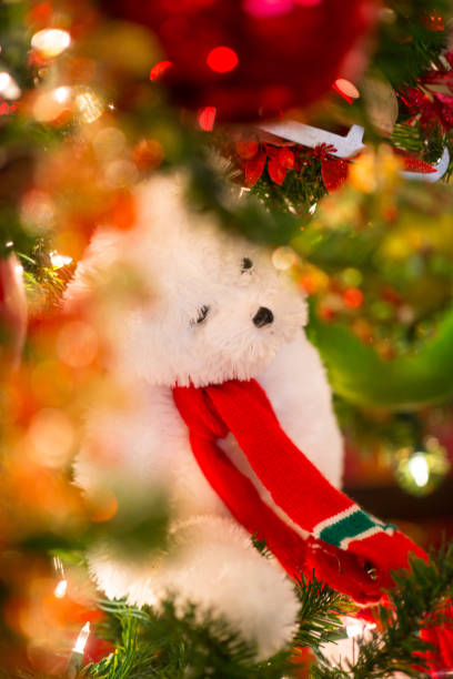 istock Cute teddy bear surrounded by sparkling Christmas ornaments 875402138