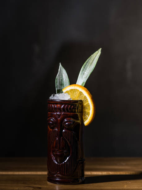 istock Exotic tropical tiki cocktails on a black background 875402236