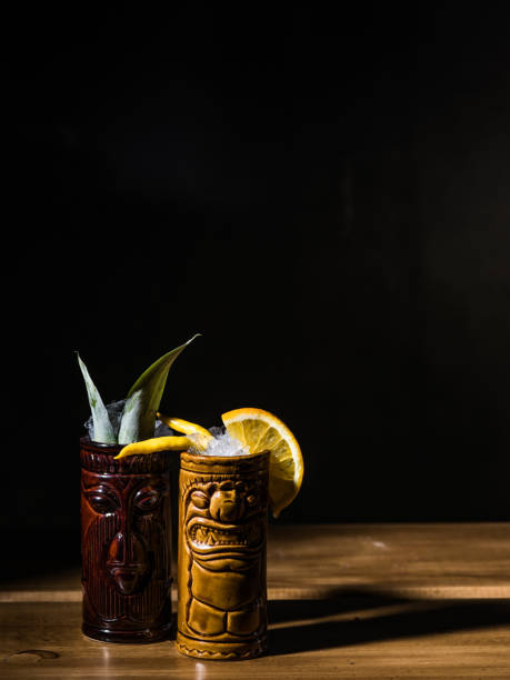 istock Exotic tropical tiki cocktails on a black background 875402694