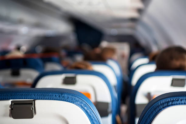 istock Close up passenger seats in cabin of plane 875402908