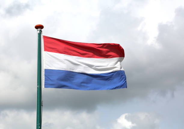 istock Dutch flag waving with blue sky 875408170