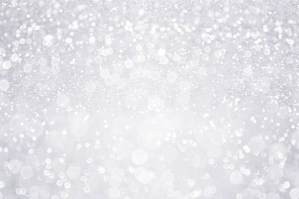 Silver White Glitter Background for Bridal, Winter or Birthday Party Sparkle Silver white glitter sparkle confetti background for happy birthday party invite, Christmas fairy lights bokeh blur, winter snow frost ice flyer, 25 anniversary or wedding glam spark shine greeting card white decoration glitter stock pictures, royalty-free photos & images