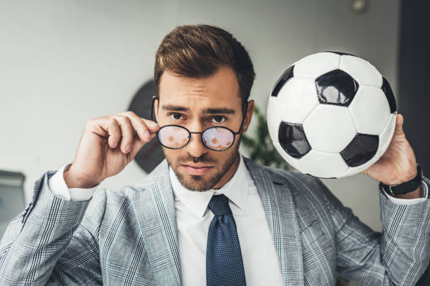istock businessman with soccer ball 875419698
