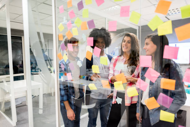 istock Multi ethnic group of creative people at a meeting brainstorming and looking very happy 875429968
