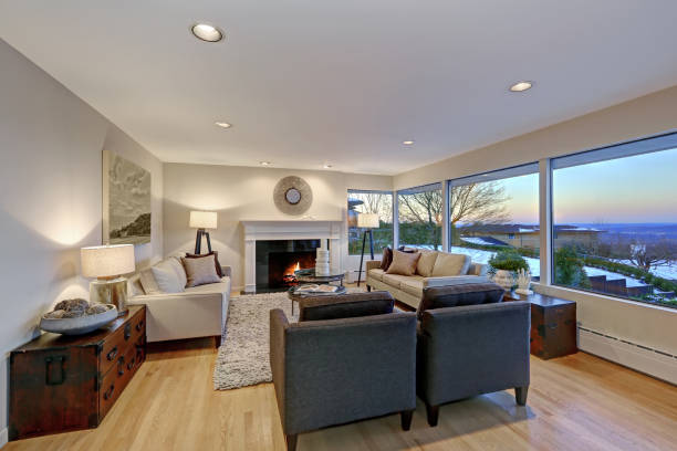 istock Warm light brown living room with panoramic window view. 875430906