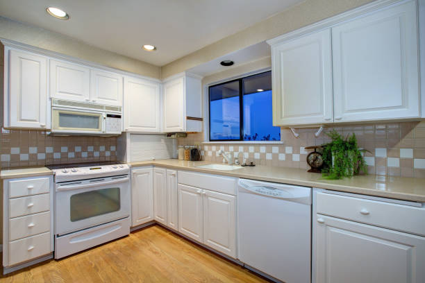 istock White kitchen design with hardwood floor and white appliances 875431002