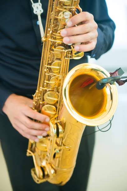 istock man playing jazz saxophone closeup 875431116