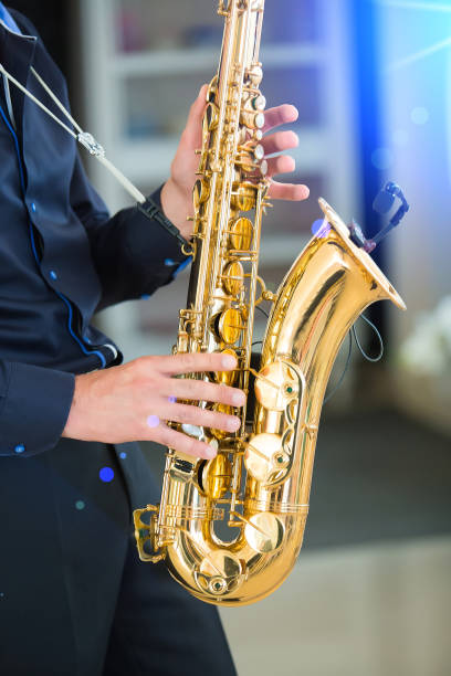 istock man playing jazz saxophone closeup 875431122