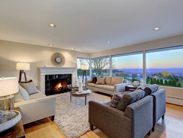 istock Warm light brown living room with panoramic window view. 875433590