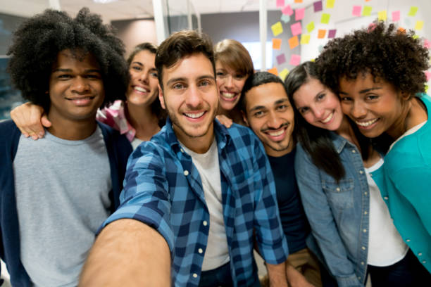 istock Multi ethnic group of designers at the office taking a selfie 875434702