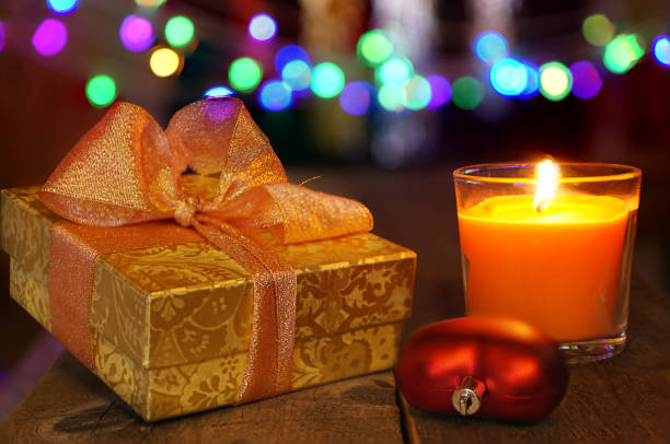 istock Christmas  decoration with candle and  gift box under cozy colored blurred background. 875441678